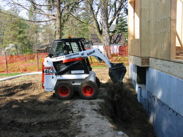 Backfilling a residential excavation site
