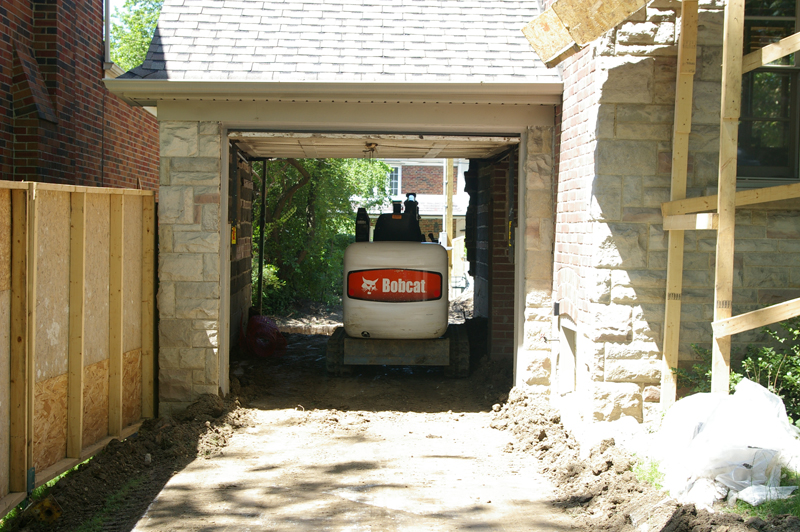 Excavating equipment maneuvering through a tight residential access point
